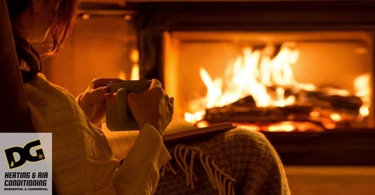 Person holding coffee in front of fireplace