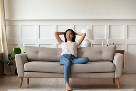 happy woman sitting on sofa