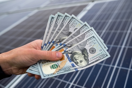 Money in Front of Solar Panel